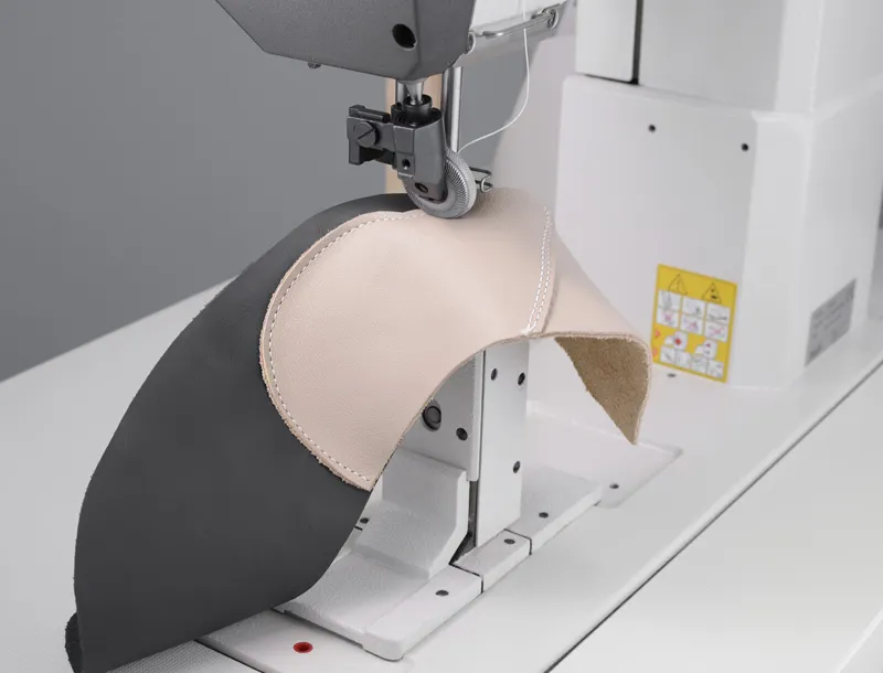 Post bed sewing machine sewing a curved footwear piece